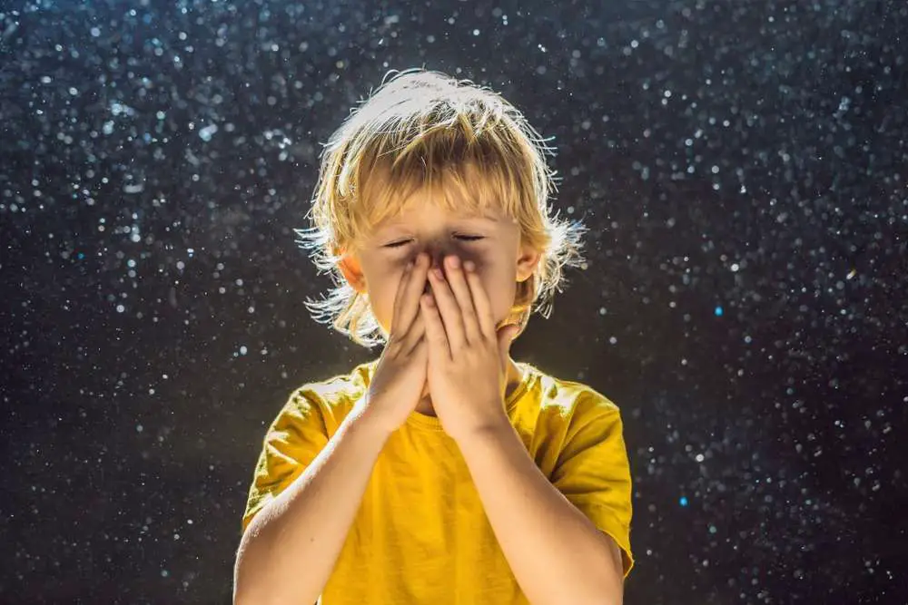A kid covers his nose, surrounded by dirty air